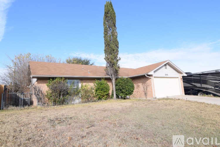 A house with a tree in front of it.