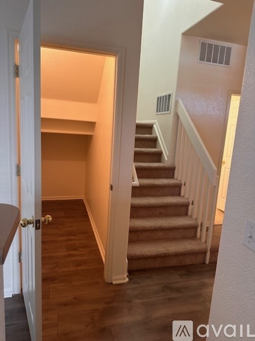 A hallway with a staircase leading to the second floor.