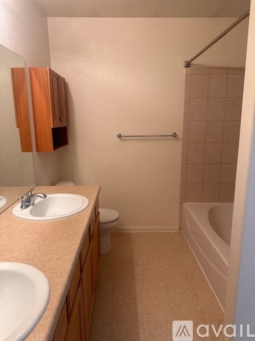 A bathroom with a sink, toilet, and bathtub.