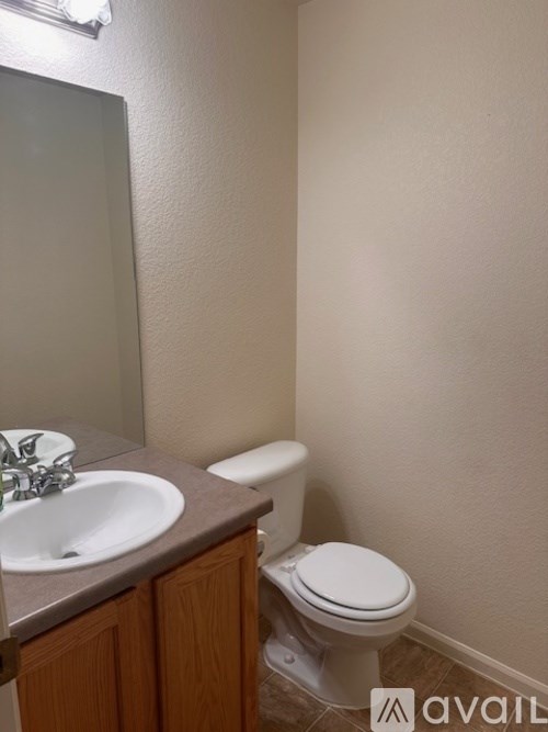 A bathroom with a toilet and sink.