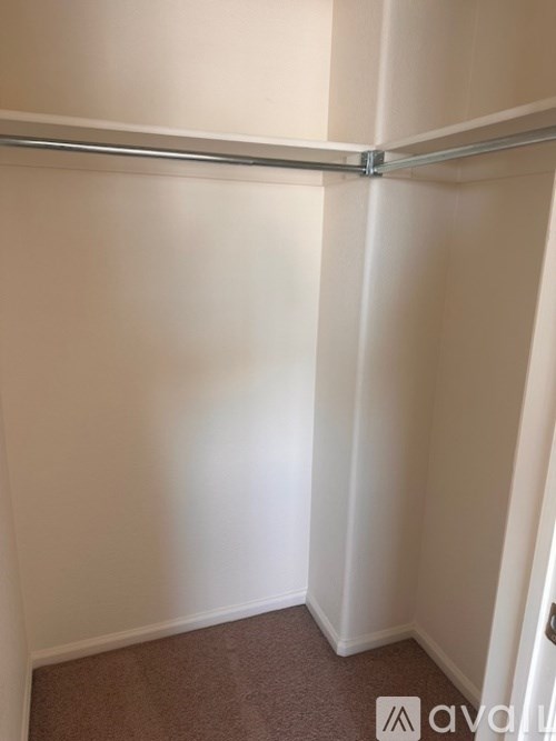 A white wall with a silver bar on it.