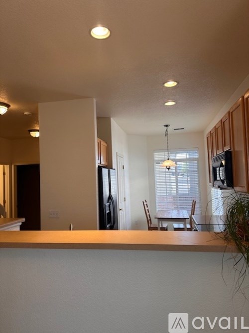 A kitchen with a dining table and chairs.