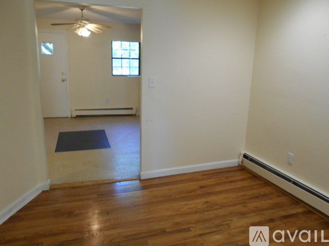 A room with wooden floors and a window.
