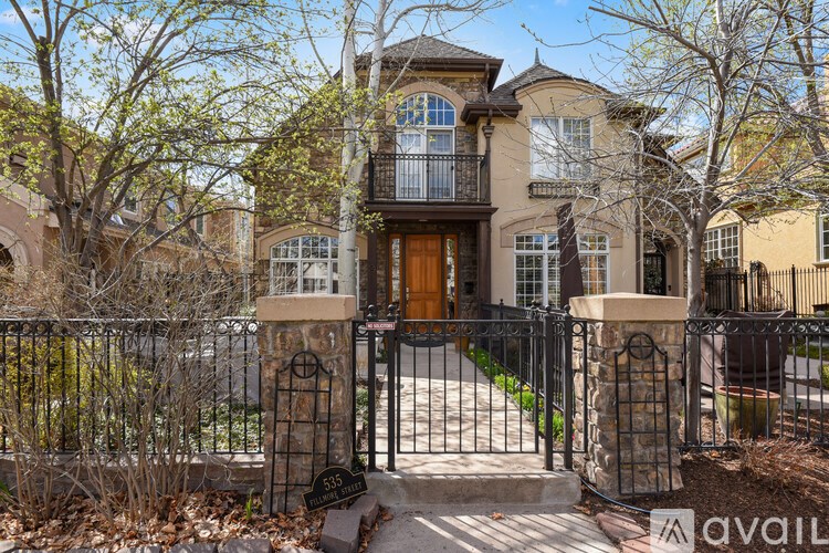 A house with a black gate and a brown door.