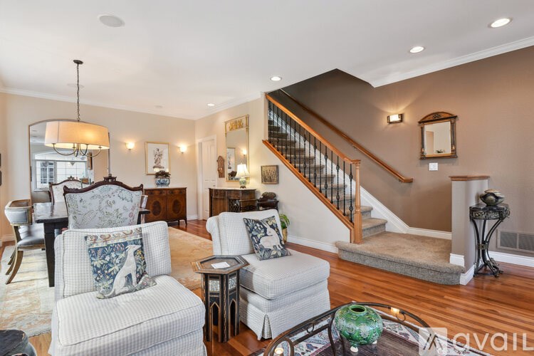 A living room with a staircase and a couch.