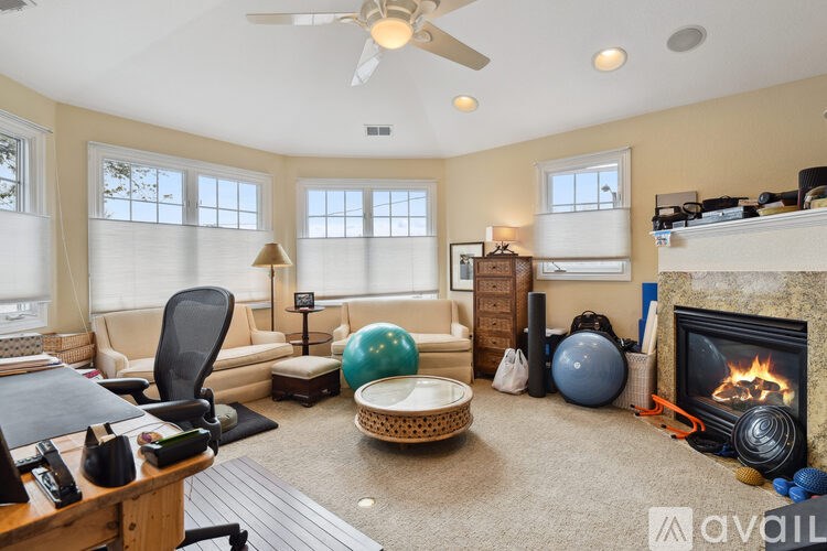 A living room with a fireplace and a chair.