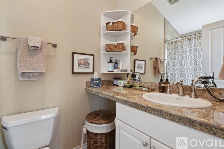 A bathroom with a white tub, sink, and towel rack.