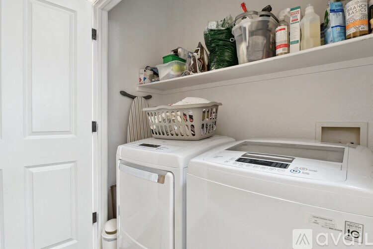 A white laundry room with a washer and dryer.