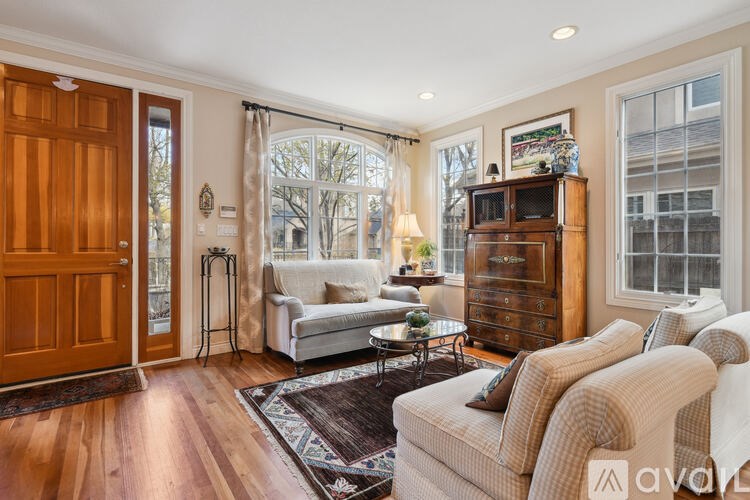 A living room with a white sofa and a wooden cabinet.