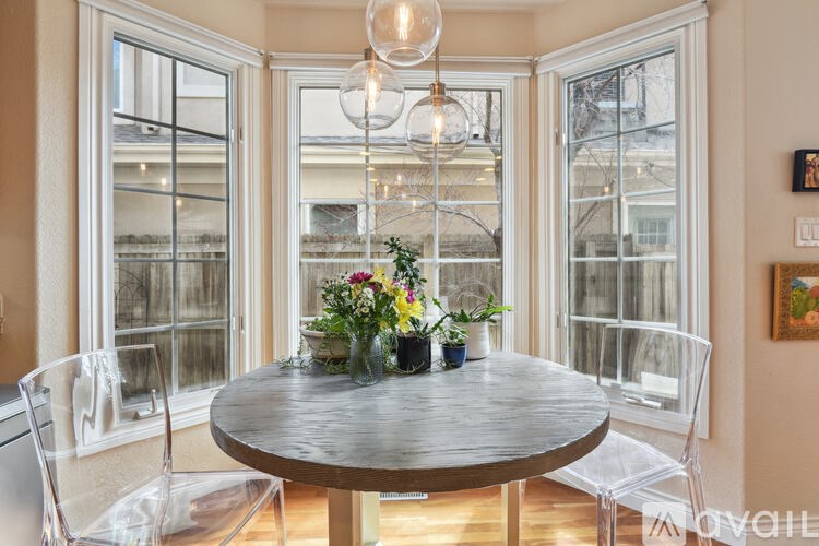 A dining room with a round table and chairs.