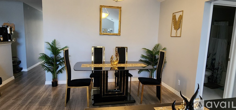 A dining room with a table and chairs.