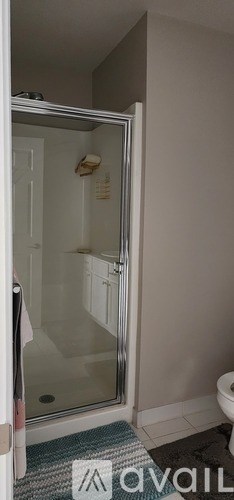 A bathroom with a toilet, sink, and mirror.