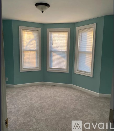 A room with two windows and a carpeted floor.