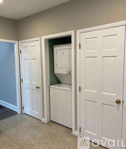 A bathroom with a toilet and a sink in a cabinet.