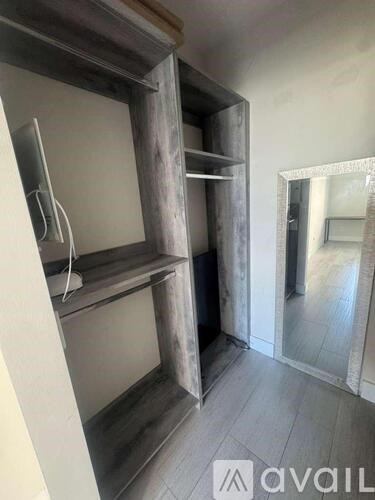 A gym with a variety of equipment including weights and a bench.