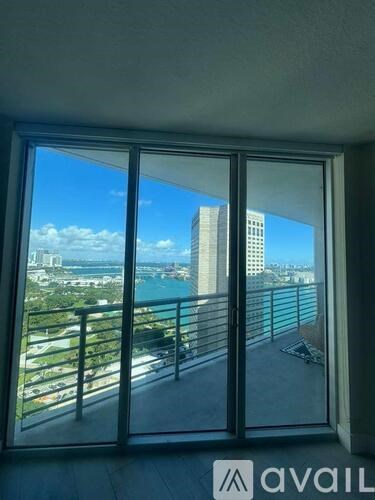 A view from a window looking out at a cityscape.