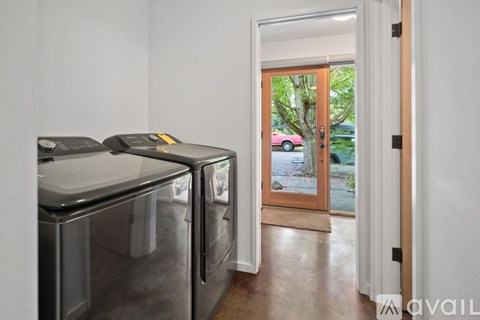 A kitchen with two dishwashers and a door leading to a balcony.