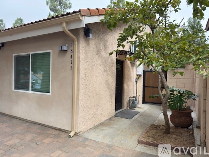 A small house with a tree in front of it.