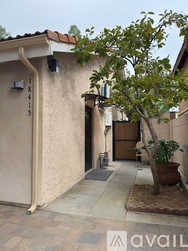 A small house with a tree in front of it.