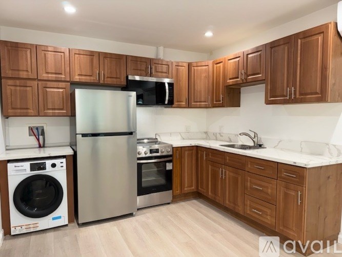 A kitchen with wooden cabinets and stainless steel appliances.