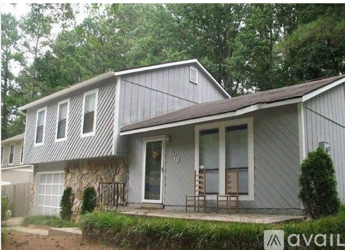 A house with a grey exterior and a brown roof.