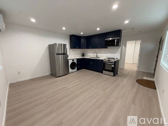 A kitchen with a refrigerator, dishwasher, and oven.