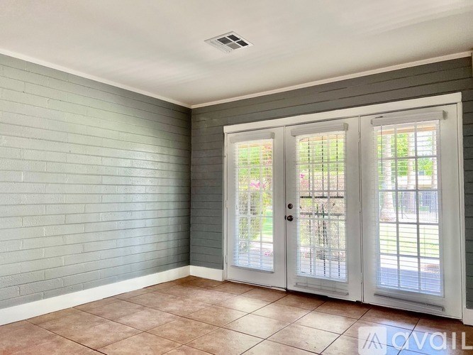 A room with a grey wall and a white door.