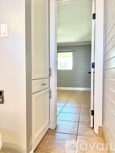 A white door is open to a hallway.