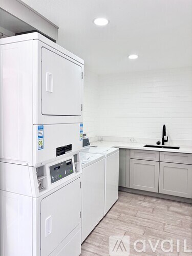 A white washing machine and dryer in a laundry room.