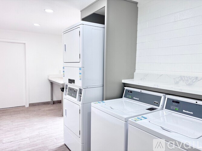 A row of washing machines in a laundry room.