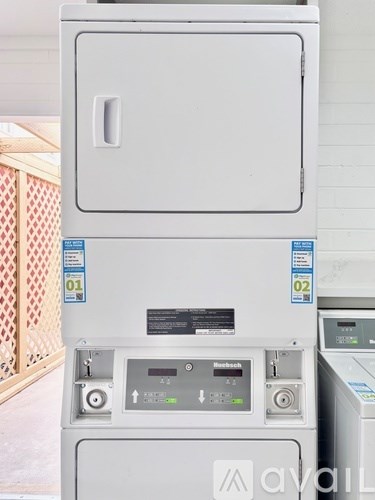 A white oven with a digital display and buttons on the front.