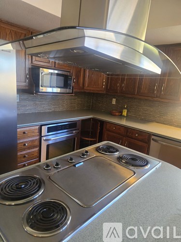A kitchen with a stove top oven and a microwave.