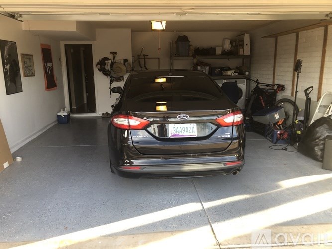 A black car is parked in a garage.