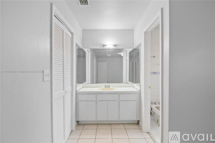 A bathroom with a sink and mirror.