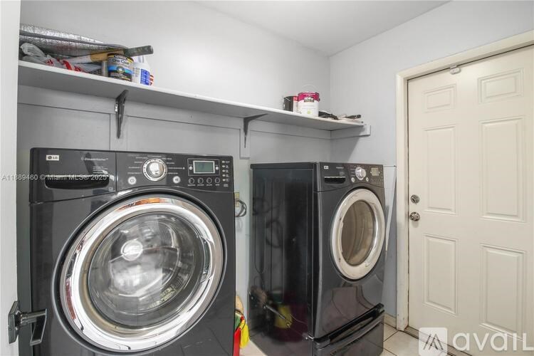Two front loading washing machines in a laundry room.