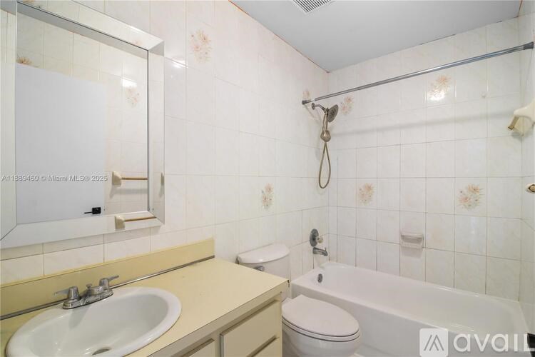 A bathroom with a sink, toilet, and bathtub.