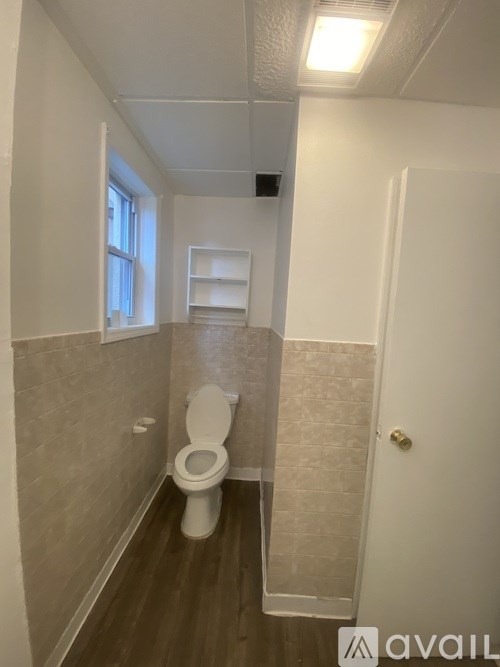 A bathroom with a toilet and a door.