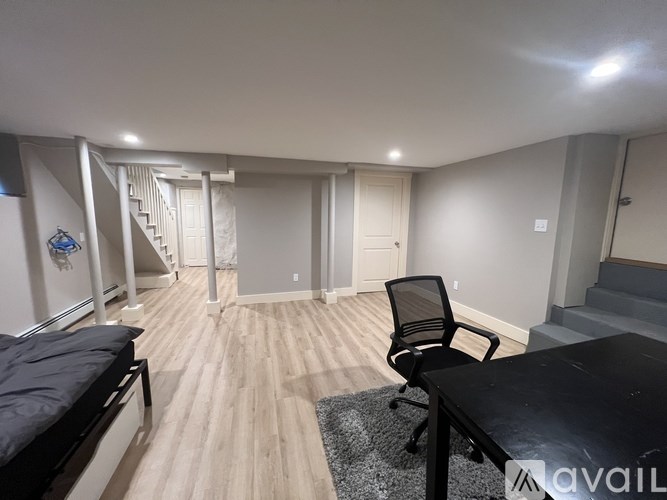 A room with a black table and a black chair.