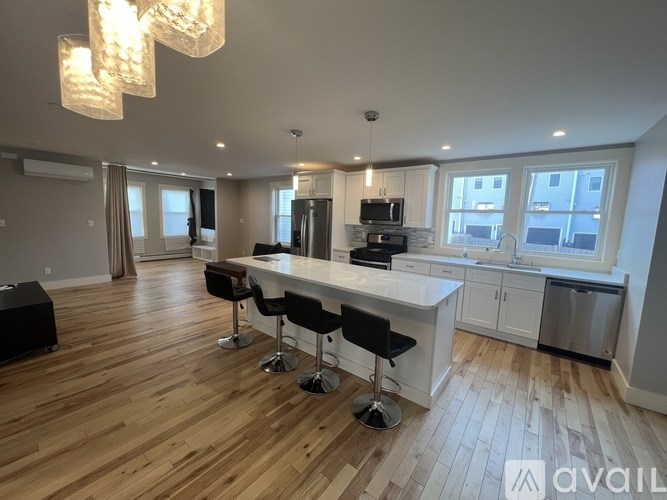 A modern kitchen with a bar area and a dining table.