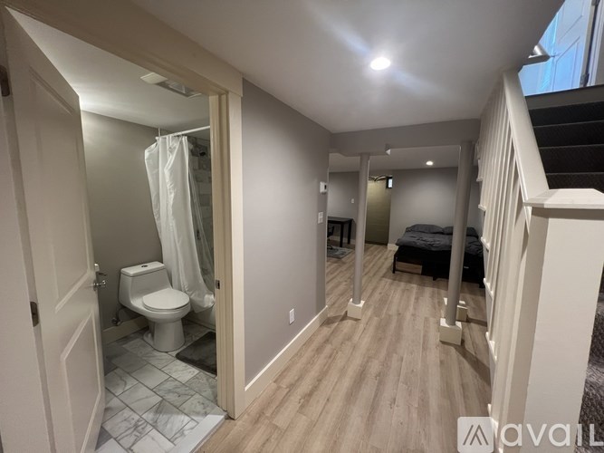 A bathroom with a toilet, sink, and shower.