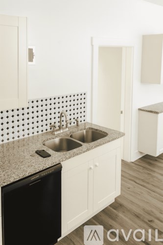 A kitchen with a sink and a dishwasher.