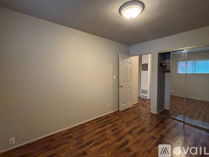 A room with wooden floors and a white door.