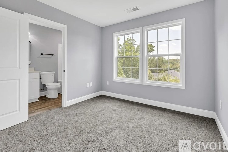 A room with a toilet and a window.