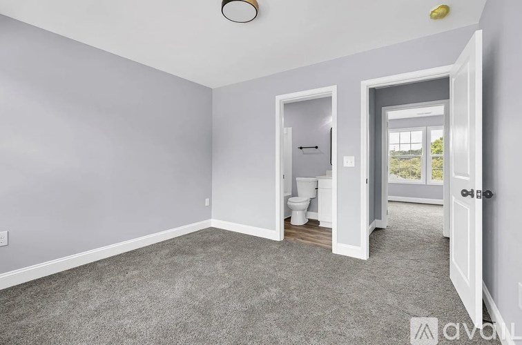 A room with a toilet and a window.