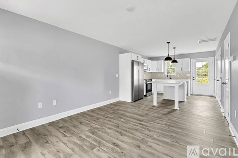 A spacious kitchen with a dining table and chairs is available for rent.