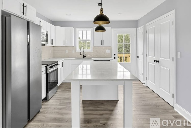 A modern kitchen with a large island in the center.