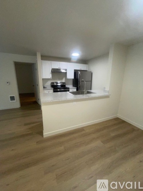 A kitchen area with a stove, oven, and refrigerator.