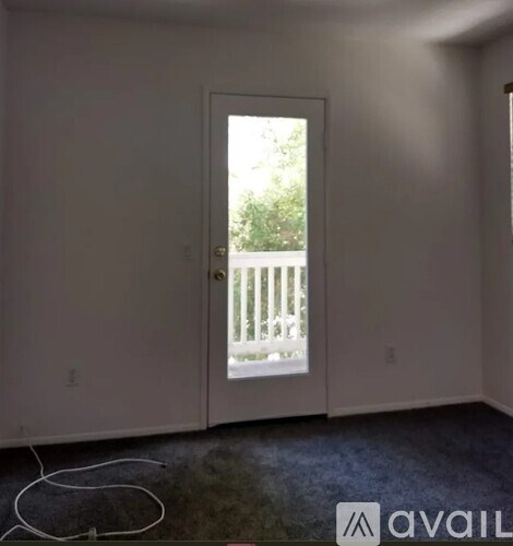 A room with a door leading to a balcony.