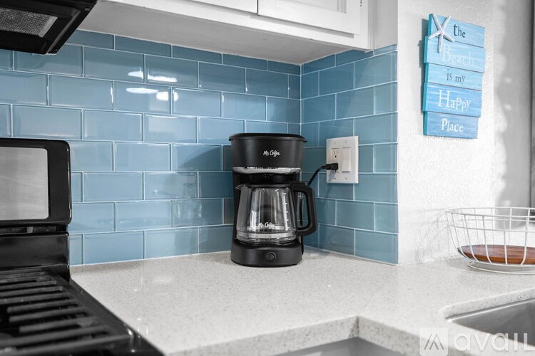 A kitchen with a black coffee maker on the counter.