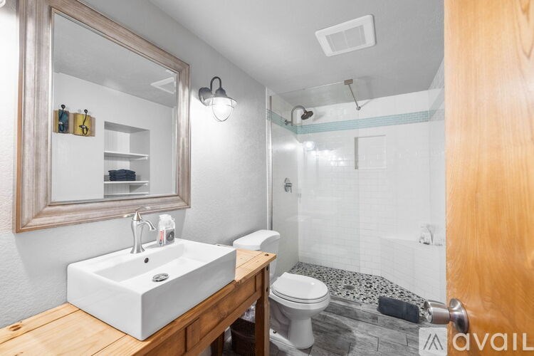 A bathroom with a white sink and a mirror above it.